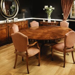 W129 CIRCULAR TABLE: Mahogany. 152cm/60in diameter ext. to oval with six extensions. W244cm/96in D167cm/66in H76cm/30in
